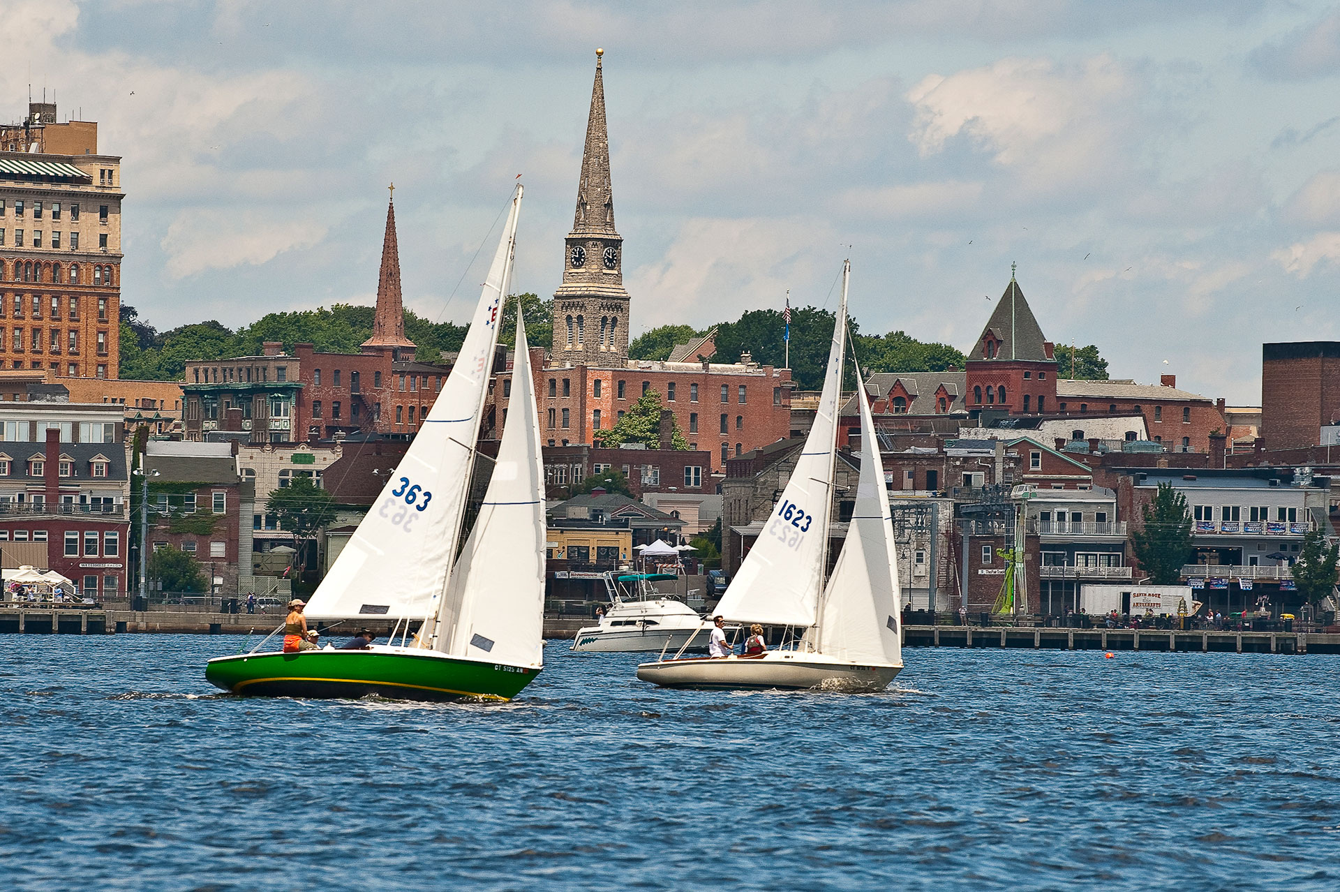 Sailboats on the Thames River in front of downtown New London